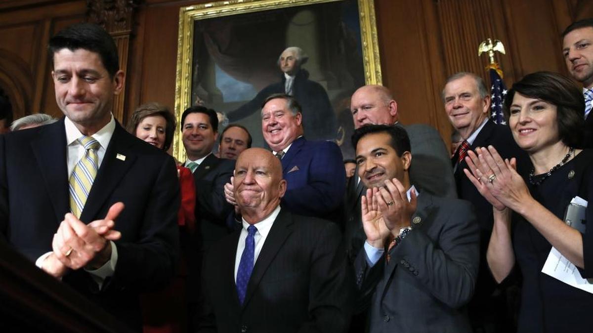 House Speaker Paul Ryan, left, leads applause for House Ways and Means Chair Rep. Kevin, Rep. Carlos Curbelo and Rep. Cathy McMorris Rodgers during a news conference following a vote on the GOP tax plan on Capitol Hill in Washington on Thursday.