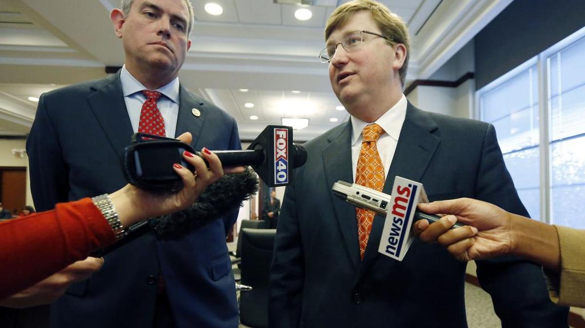 Mississippi Lt. Gov. Tate Reeves, right speaks to reporters on the merits of the Joint Legislative Budget Committee's $6 billion spending blueprint for fiscal 2016.