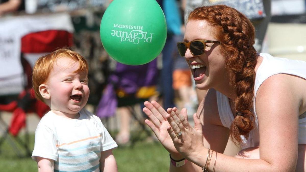 Lindsay Dengler of Gulfport and her son, William, 1, play with a balloon at the Mississippi Bicentennial South celebration at Centennial Plaza in Gulfport on Saturday, April 1, 2107.