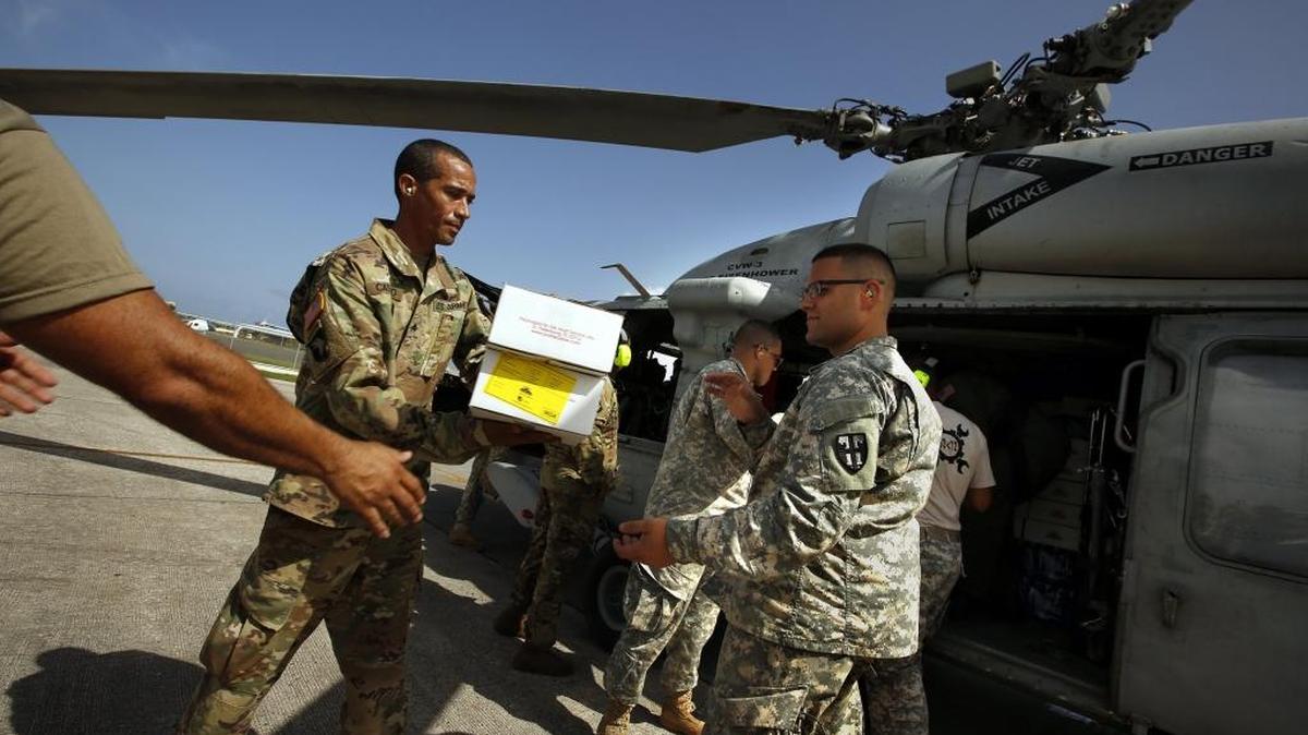 In a joint operation between the U.S. Navy and the Puerto Rico National Guard, FEMA food is loaded onto helicopters to be taken to remote parts of the island on Thursday, Sept. 28, 2017.