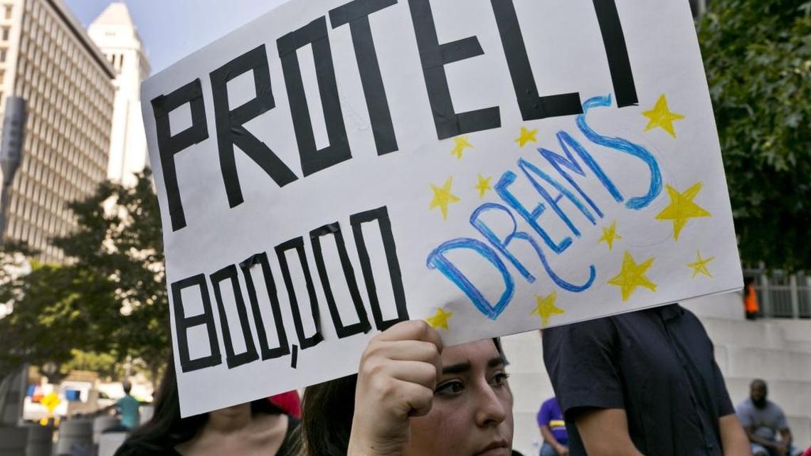 FILE - In this Sept. 1, 2017 file photo, a woman joins a rally in support of the Deferred Action for Childhood Arrivals, or DACA program, outside the Edward Roybal Federal Building in downtown Los Angeles Friday, Sept. 1, 2017. (AP Photo/Damian Dovarganes, File)