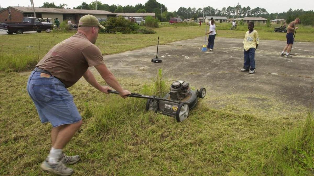 U.S. Navy Seabee Builder First Class Carl Hardgrove, 33, mows grass at W. M. Ladnier homes in this 2004 file photo. Sound Off contributor says she’s happy to help her neighbors.