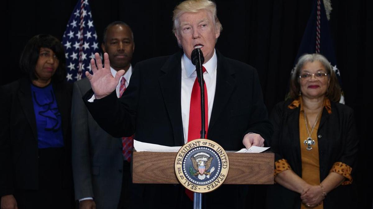 President Donald Trump speaks after touring of the National Museum of African American History and Culture, Tuesday, Feb. 21, 2017, in Washington. From left are, Candy Carson, Housing and Urban Development Secretary-designate Dr. Ben Carson, Trump, and Alveda King, niece of Dr. Martin Luther King Jr.
