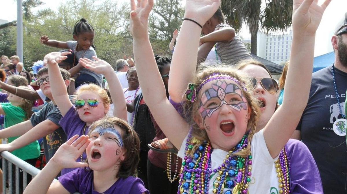 Marin Clayton, 6, of Biloxi and her sister, Elizabeth, call for throws during the Gulf Coast Carnival Association Mardi Gras parade in Biloxi on Tuesday, Feb. 28, 2017.