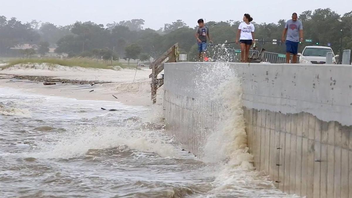 A family walks Thursday, June 22, 2017, on the boardwalk near Hewes Avenue in Gulfport where the beach has eroded to the seawall. A project to replenish the beach in Harrison County will start in October.