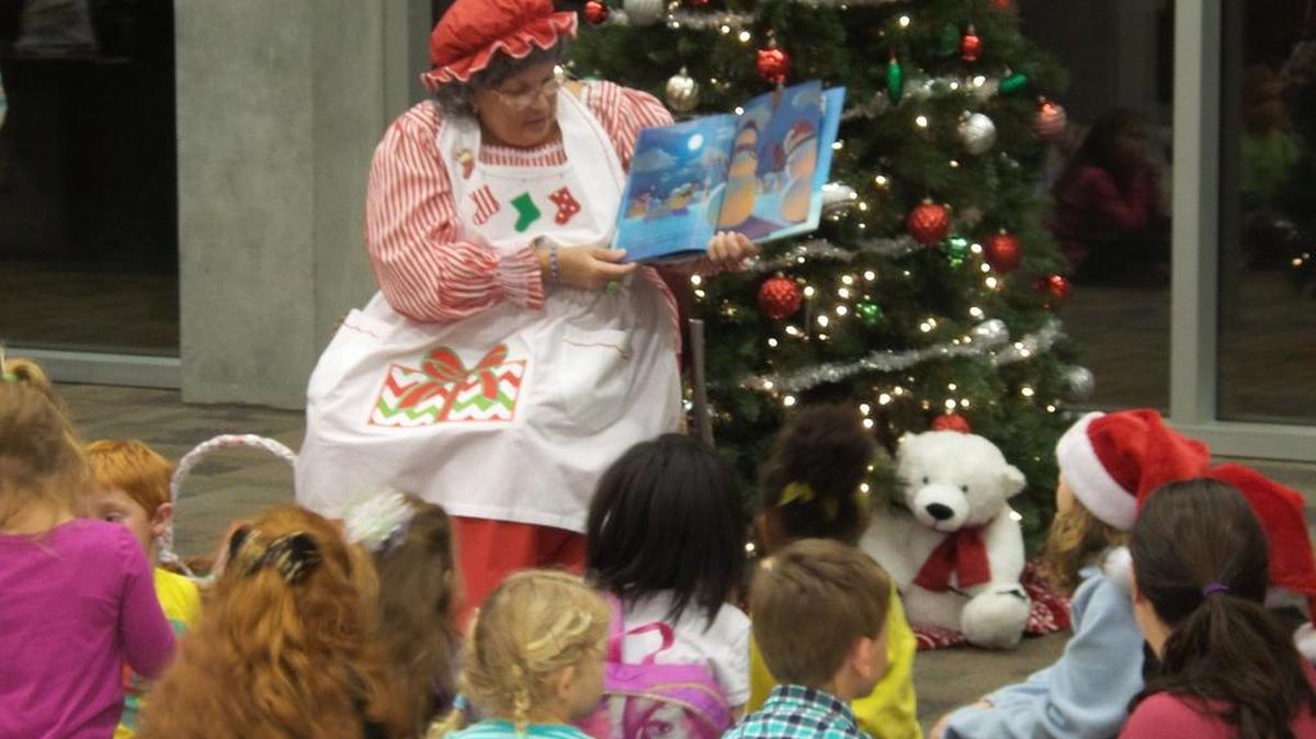 Mona Franzen dressed as Mrs. Claus reads to children at the Gulfport branch of the Harrison County Library last year.