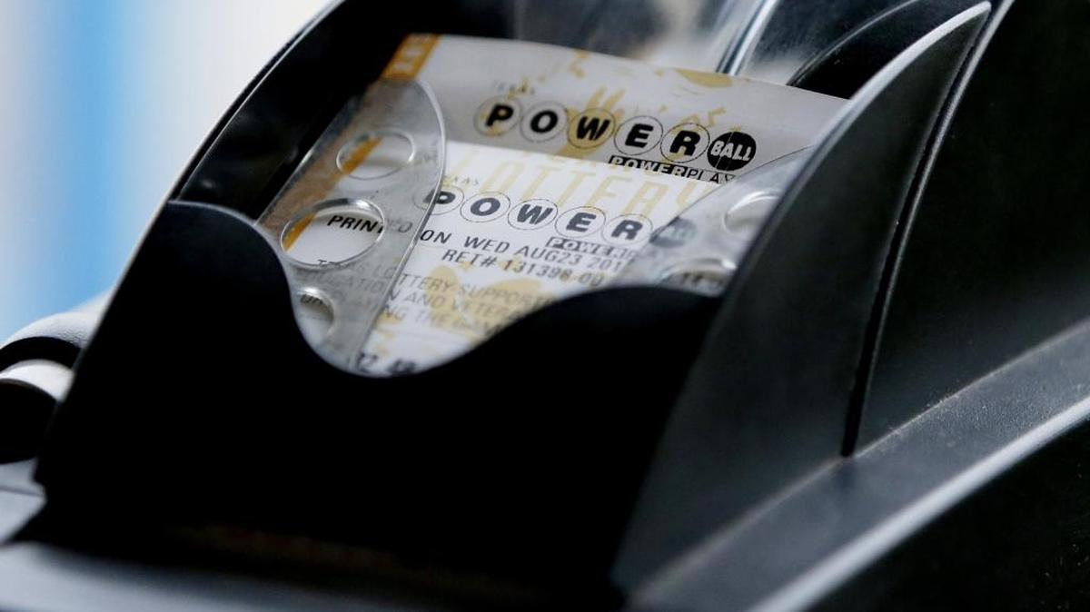 FILE - In this Aug. 23, 2017 file photo, a Powerball lottery ticket is printed on a lottery machine at a convenience store.