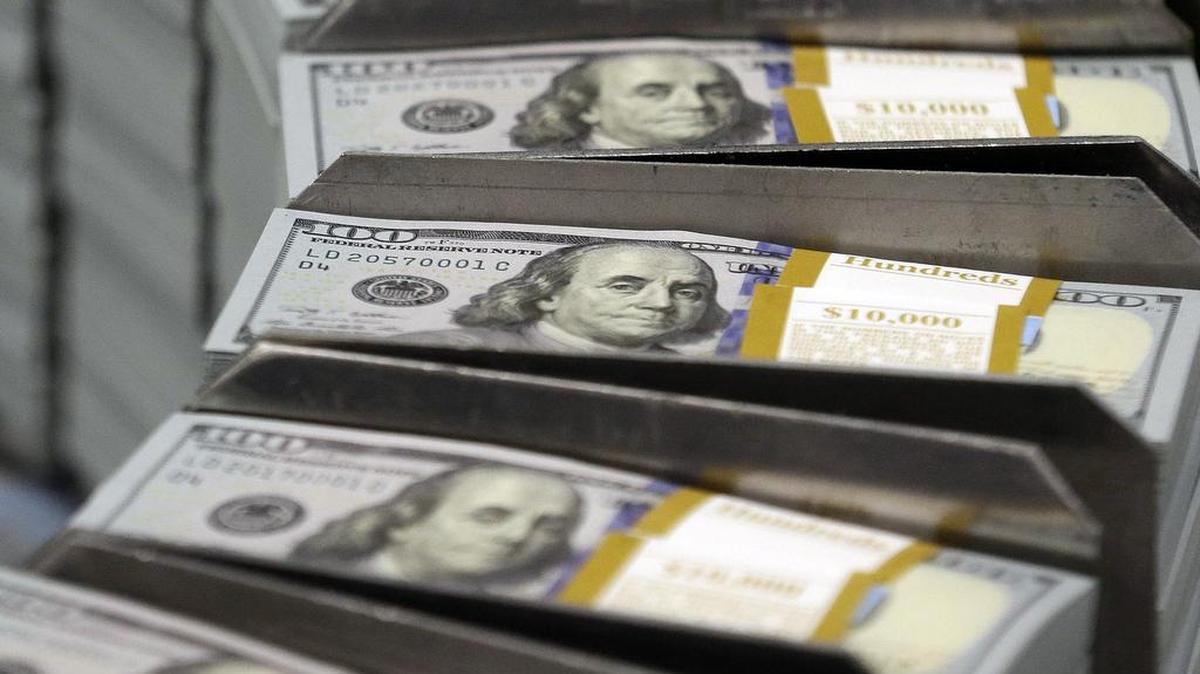 In this Sept. 24, 2013, file photo, just cut stacks of $100 bills make their way down the line at the Bureau of Engraving and Printing Western Currency Facility in Fort Worth, Texas. Big U.S. companies have been piling up cash for years, but have spent little of it on buying equipment and raising wages and other things to grow the economy. Republicans say they know how to fix this: Give companies even more money by cutting their taxes.