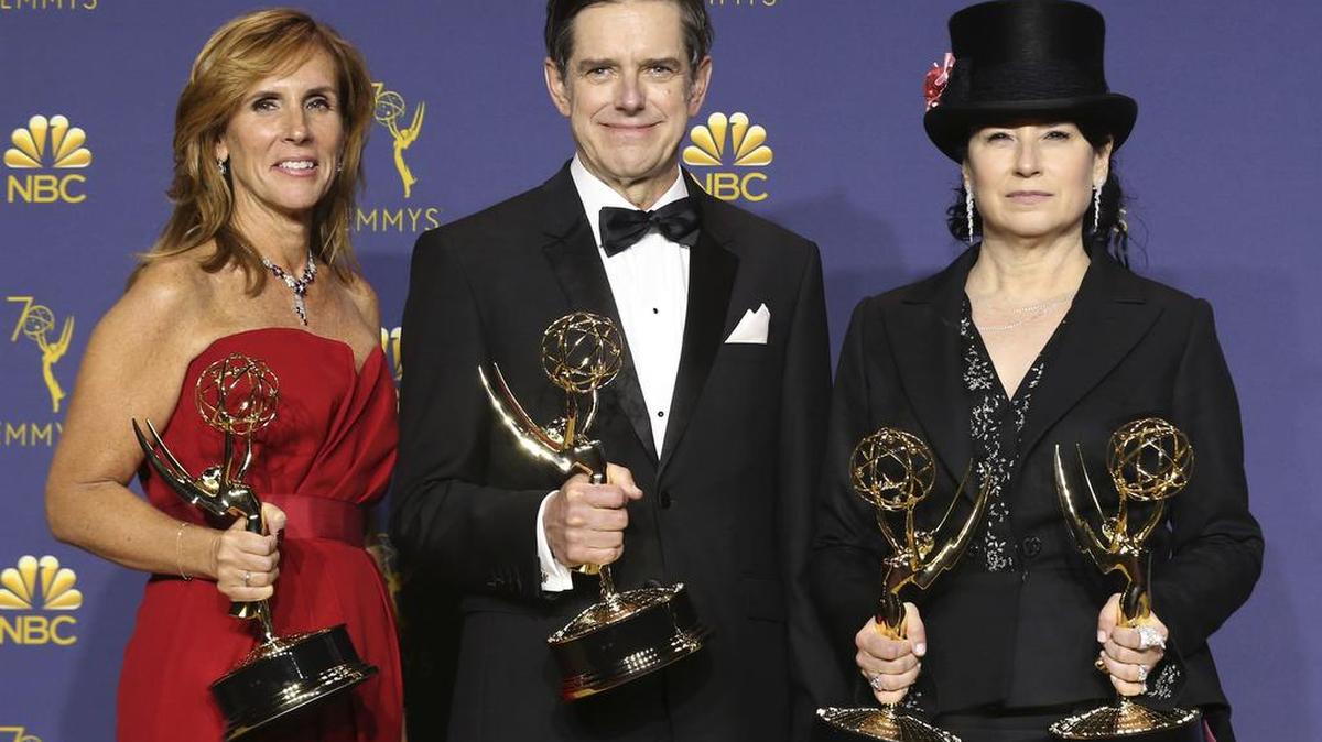 Writers, from left, Sheila Lawrence, Daniel Palladino, and Amy Sherman-Palladino pose in the press room with the award for outstanding writing for a comedy series and the award for outstanding comedy series for ‘The Marvelous Mrs. Maisel’ at the 70th Primetime Emmy Awards on Monday.