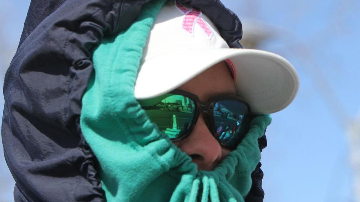 Michelle Girouard of Ocean Springs bundles against the cold during the Biloxi Children's Walking Mardi Gras parade on Monday March 3, 2014.