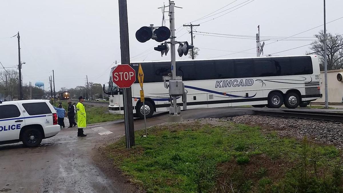 A Kincaid tour bus sits stuck at the Main Street railroad crossing on March 12, 2016. A CSX train that was stopped before it hit the train can be seen.
