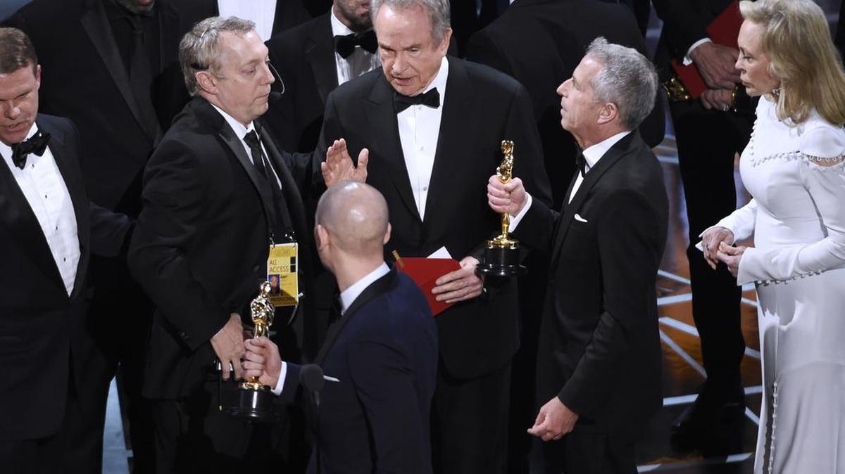 Warren Beatty, center, discusses the results of the award for best picture with Academy of Motion Pictures Arts and Sciences officials and producers from "La La Land" at the Oscars on Sunday, Feb. 26, 2017, at the Dolby Theatre in Los Angeles.