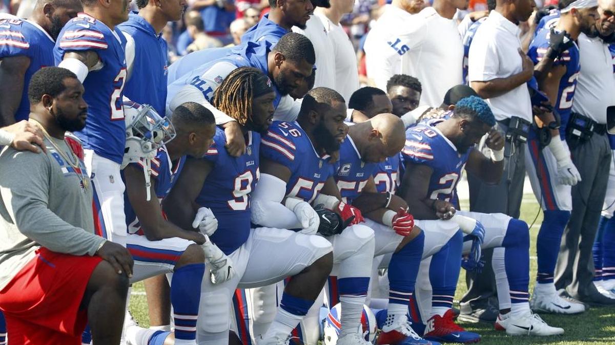FILE - In this Sunday, Sept. 24, 2017, file photo, Buffalo Bills players take a knee during the playing of the national anthem prior to an NFL football game against the Denver Broncos in Orchard Park, N.Y. What began more than a year ago with a lone NFL quarterback protesting police brutality against minorities by kneeling silently during the national anthem before games has grown into a roar with hundreds of players sitting, kneeling, locking arms or remaining in locker rooms, their reasons for demonstrating as varied as their methods.