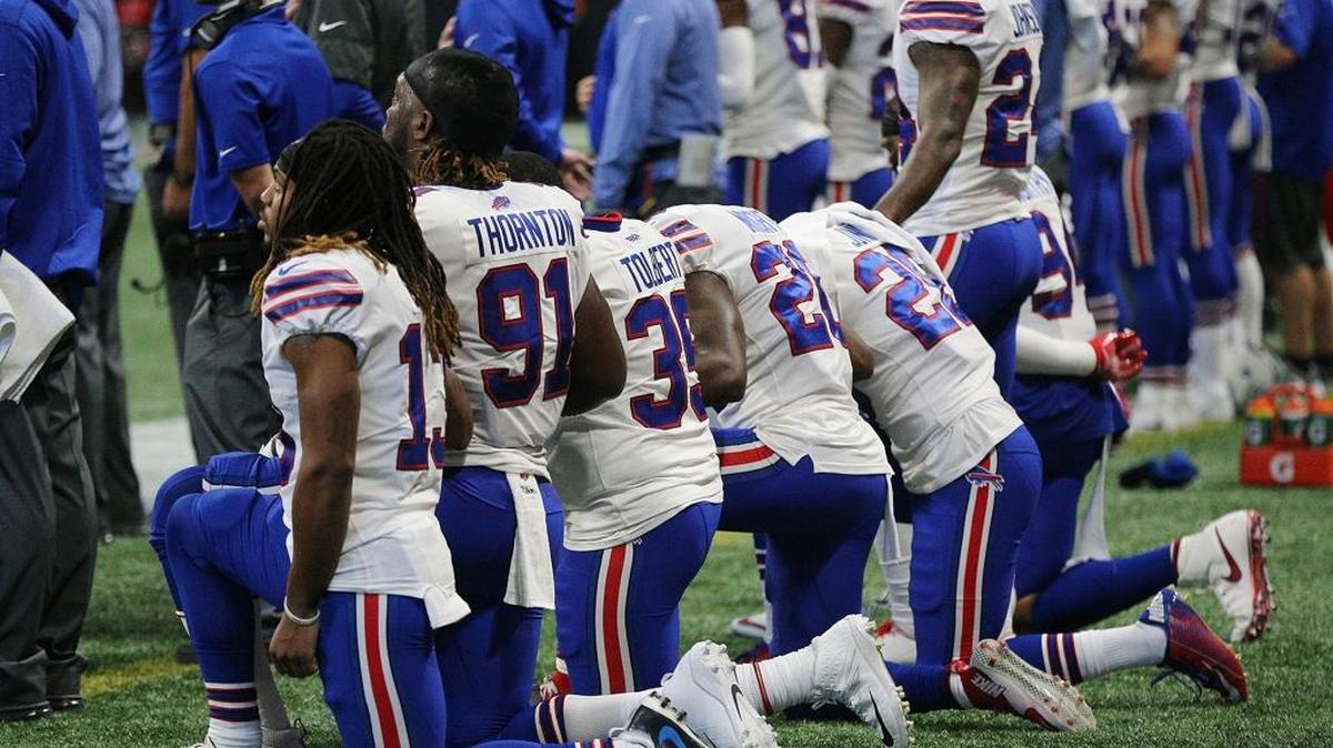 Many of the Buffalo Bills players kneel on the sidelines for the national anthem against the Atlanta Falcons on Sunday, Oct. 1, 2017, in Atlanta, Georgia.