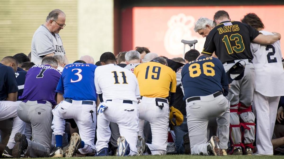 Patrick Conroy, Chaplain of the House of Representatives, left, leads both teams in a moment of prayer before the start of the annual Congressional Baseball Game at Nationals Park on Thursday, June 15, 2017 in Washington, D.C.