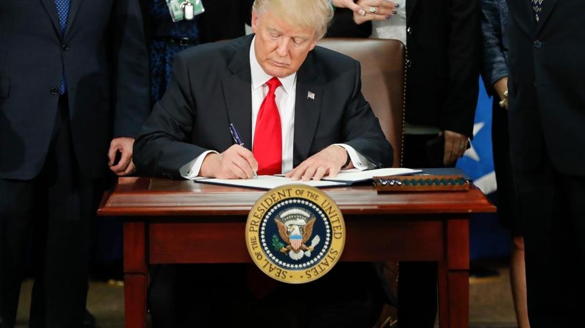 President Donald Trump signs an executive order Jan. 25 for border security and immigration enforcement improvements at the Department of Homeland Security in Washington. Immigration to the United States has come in swells and dips over the past two-plus centuries, driven by shifts in US policy, the mood in the country and world events.