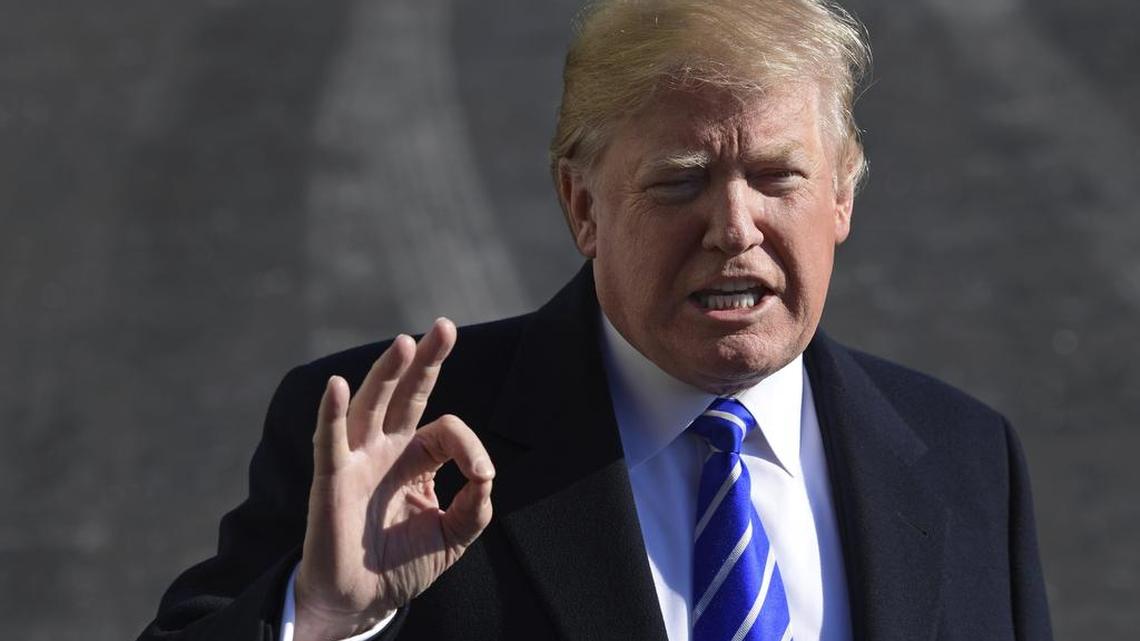 President Donald Trump talks with reporters as he departs from the South Lawn of the White House via Marine One in Washington, Saturday, Dec. 16, 2017, to spend the weekend at Camp David in Maryland.