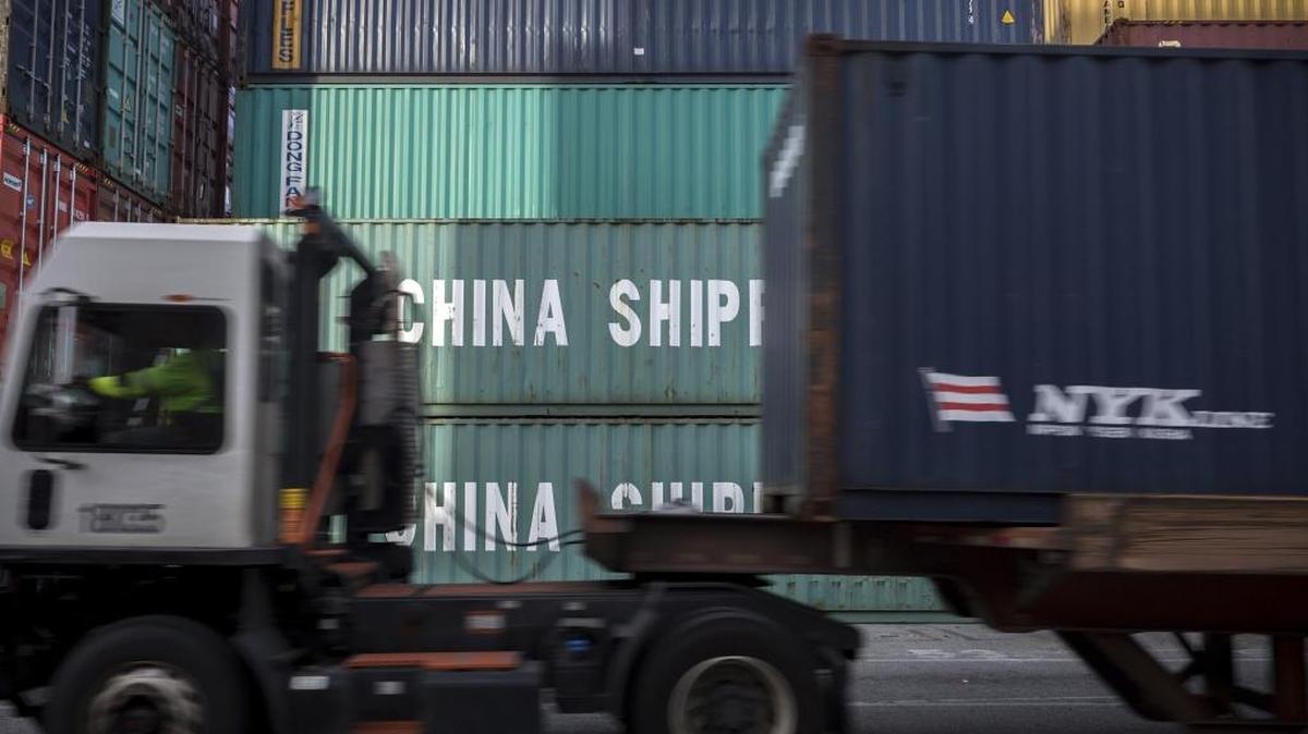 In this Thursday, July, 5, 2018 photo, a jockey truck passes a stack of 40-foot China Shipping containers at the Port of Savannah in Savannah, Ga. The United States and China launched what Beijing called the “biggest trade war in economic history” Friday, July 6, imposing tariffs on billions of dollars of each other’s goods amid a spiraling dispute over technology. (AP Photo/Stephen B. Morton)