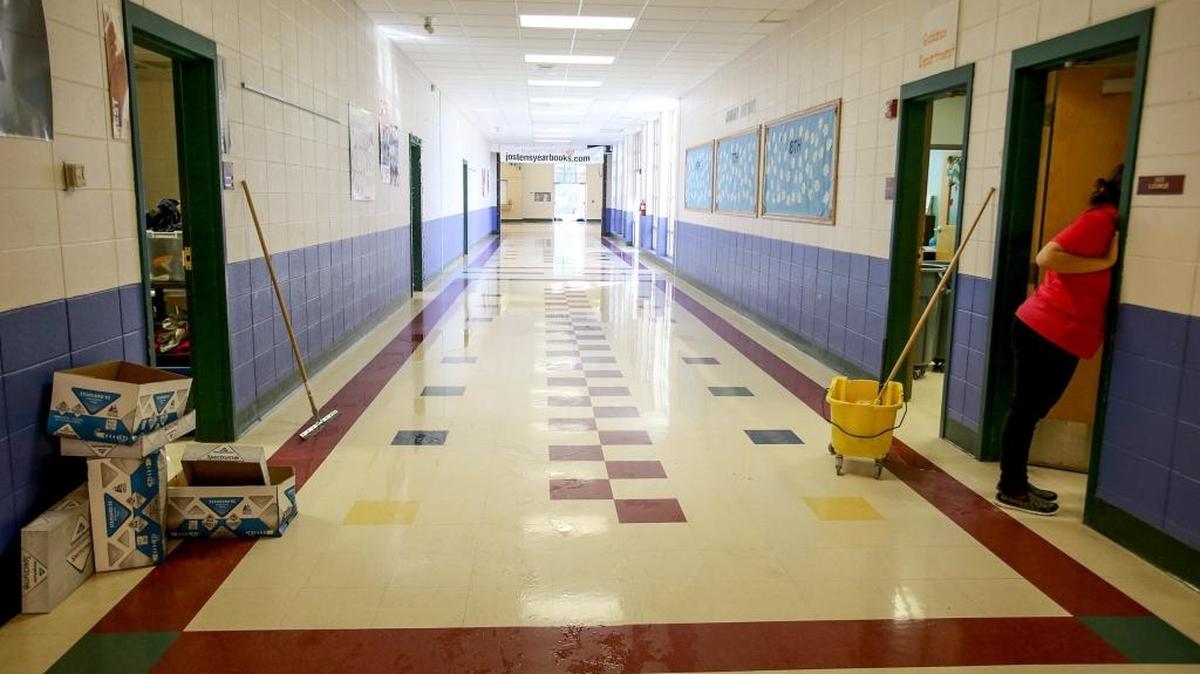 Members of the Hancock County Middle School’s custodial service ABM clean classroom at Hancock County Middle School after a small fire triggered the sprinkler system in the early hours of Monday, January 23, 2016. The sprinklers ran for nearly four hours, causing flooding in numerous classrooms. Hancock County School District Assistant Superintendent Donnie Gholston said they hope to be able to have students return to school by Wednesday.