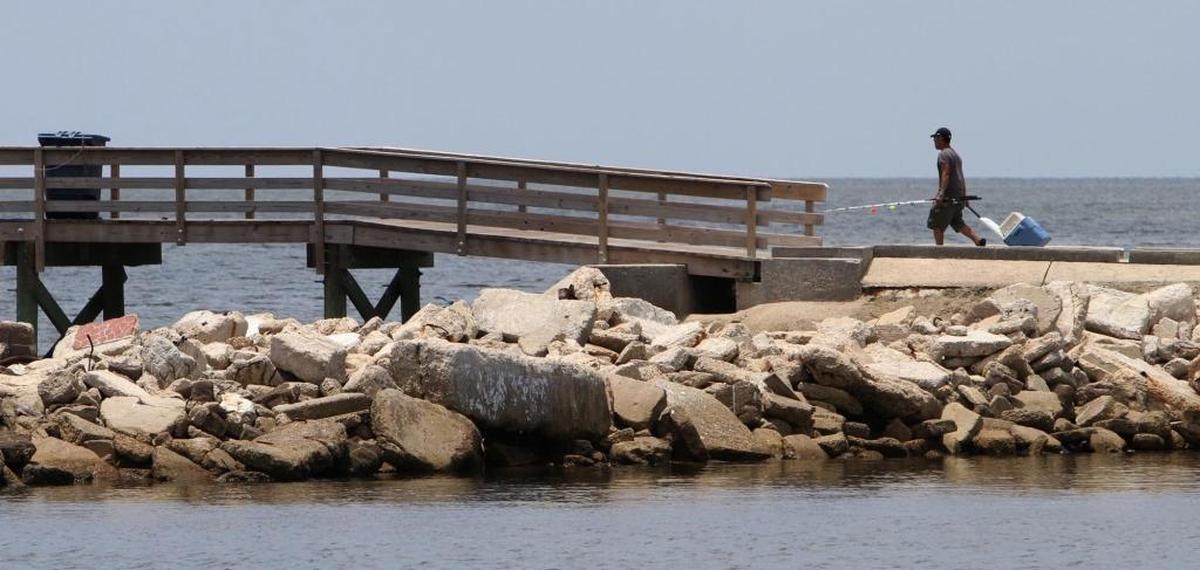 A fishermen walks along the jetty to the west pier at Long Beach Harbor in this Sun Herald file photo. Millions of dollars in grants from tidelands and GOMESA will pay for improved jetties, boat launches, piers and infrastructure across South Mississippi.