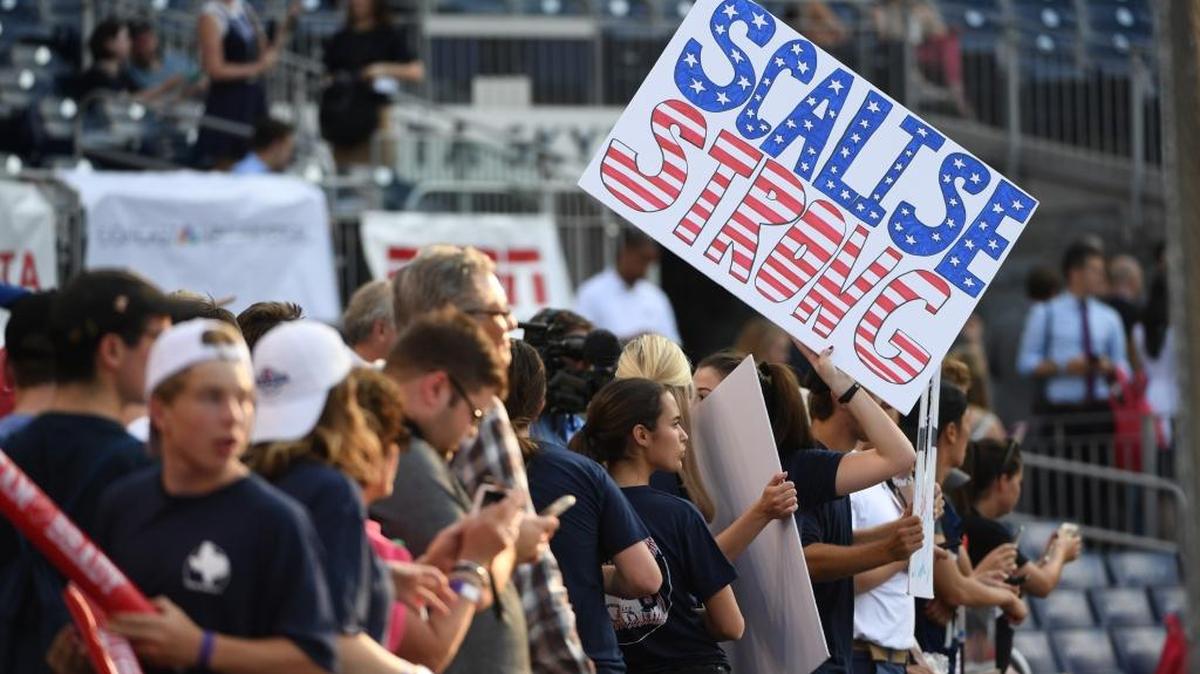 Fans hold up signs supporting Rep. Steve Scalise, who was shot during practice for the Congressional Baseball Game on Wednesday.