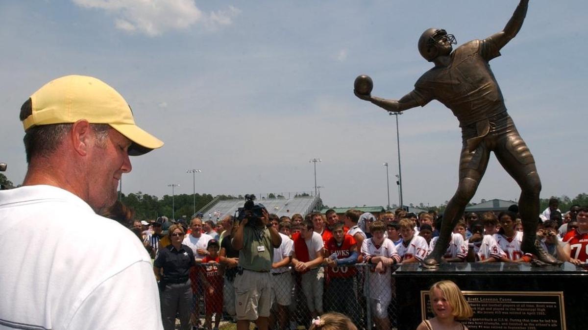Brett Favre watches as statue is unveiled at Hancock High School.