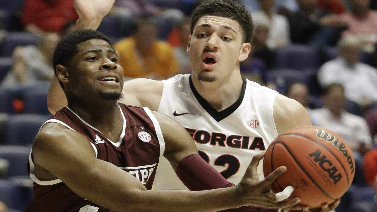 Mississippi State's Malik Newman (14) loses the ball as he drives around Georgia's Mike Edwards (32) during the first half of an NCAA college basketball game in the Southeastern Conference tournament in Nashville, Tenn., Thursday, March 10, 2016. (AP Photo/Mark Humphrey)
