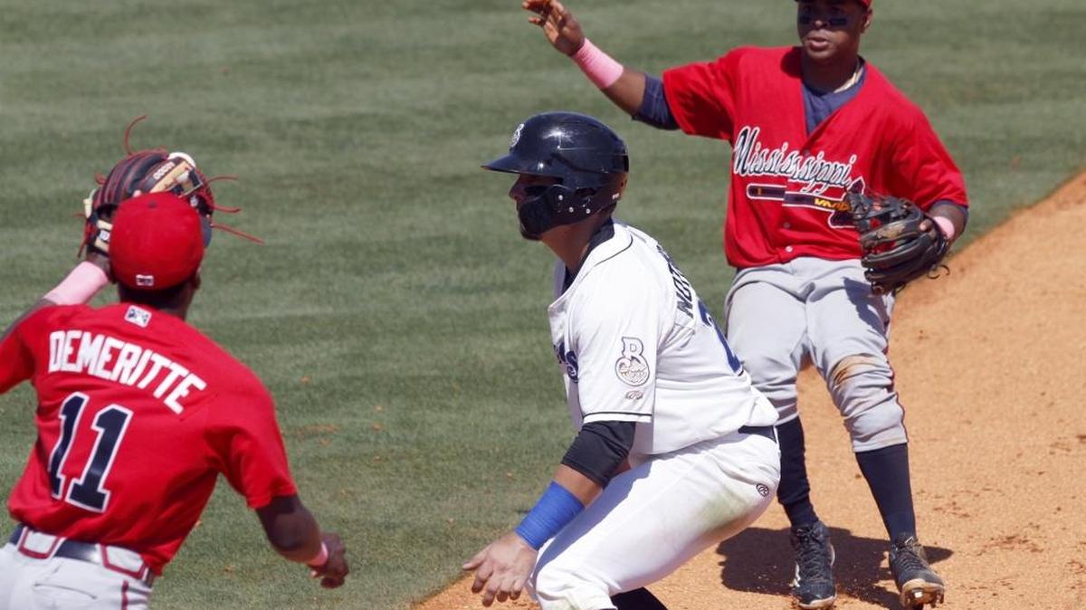 Jacob Nottingham is caught in a run down between Travis Demeritte and Luis Valenzuela during game between the Shuckers and Braves on Sunday at MGM Park.