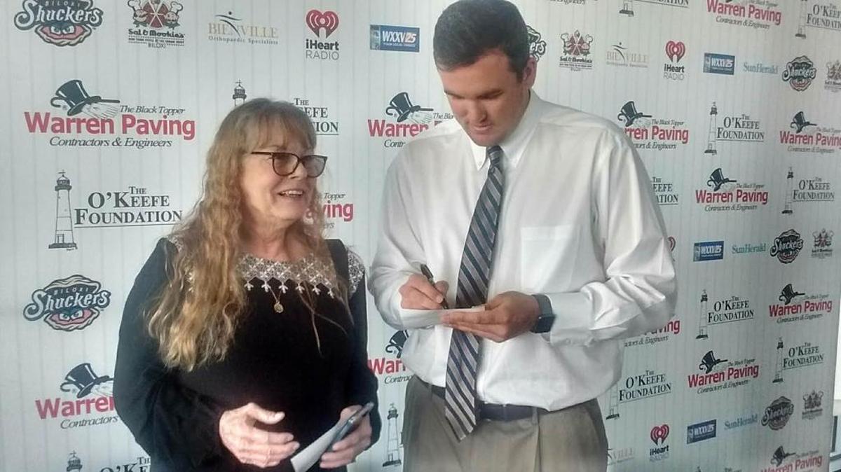 Gulfport’s Jonathan Holder signs an autograph for Becky Ainsworth. Holder spoke Friday at the Ohr-O'Keefe Our Love Affair with Baseball luncheon about his rise to the New York Yankees.