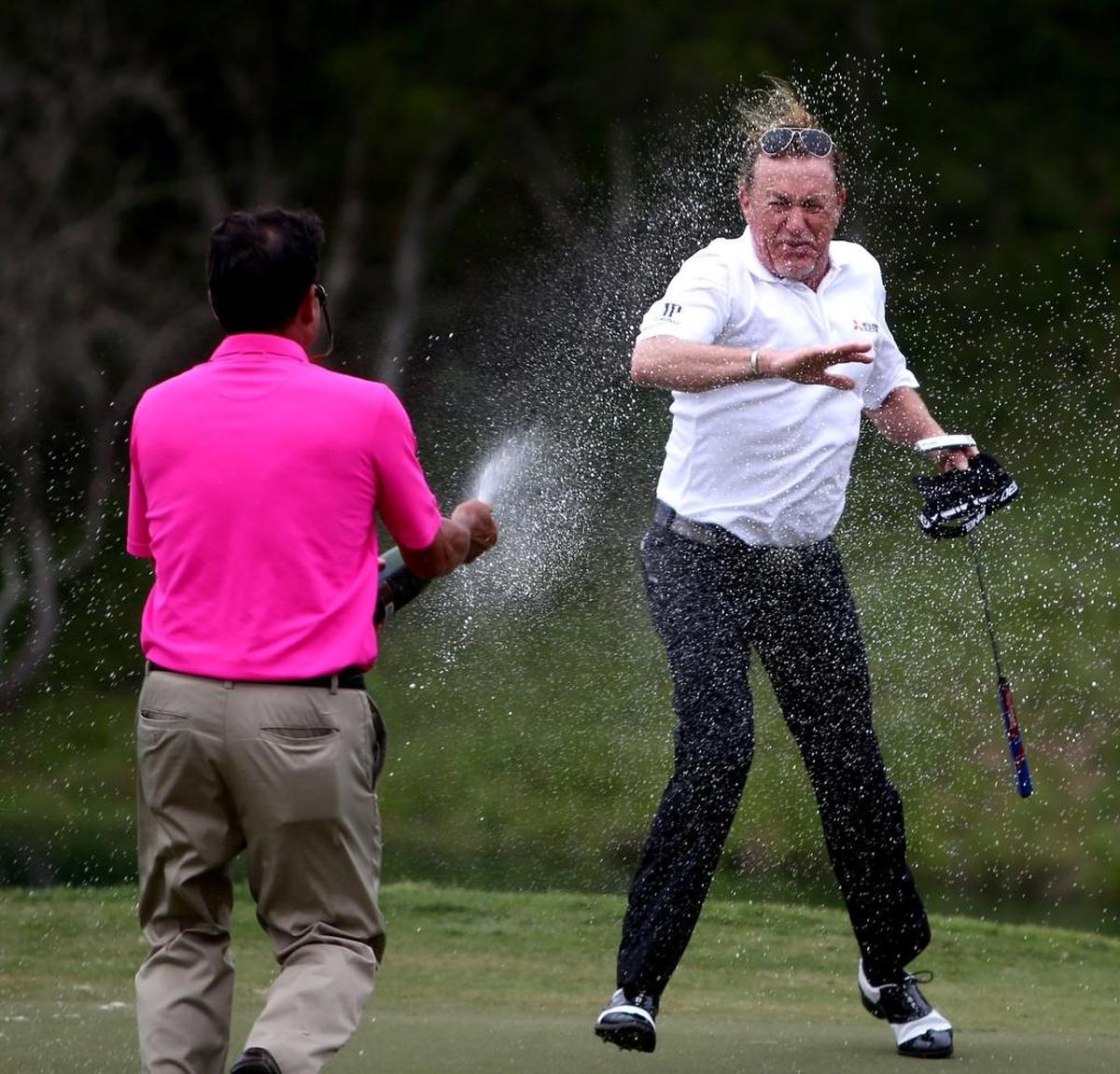Miguel Jimenez successfully defended his Mississippi Gulf Resort Championship by winning another at Fallen Oak. A friend douses Jimenez with champagne after a playoff round against Gene Sauers. Photographer’s comment: I was hoping for something other than the golf tip-of-the-cap photo. I was rewarded with Miguel Jimenez getting a champagne shower after winning in a playoff round.