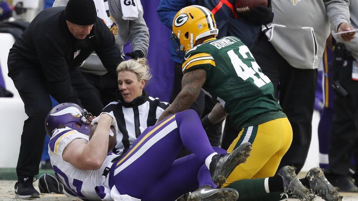 Line judge Sarah Thomas (53) is hit by Minnesota Vikings' Kyle Rudolph and Green Bay Packers' Morgan Burnett (42) during the second half of an NFL football game Saturday in Green Bay, Wis.