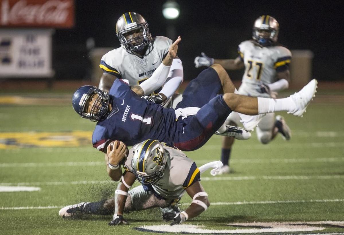 Mississippi Gulf Coast Community College defensive back Ty Peters, bottom, takes down Southwest Mississippi Community College quarterback Juwan Adams, with the help of teammate Jacobi Hearn on Oct. 12 in Perkinston. Photographer’s comments: This is another peak action shot that works well because of the quarterback’s orientation toward the camera.