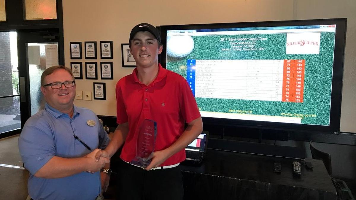 Diamondhead Director of Golf Chris Altest presented the Coast Open trophy to Jackson Wedgeworth