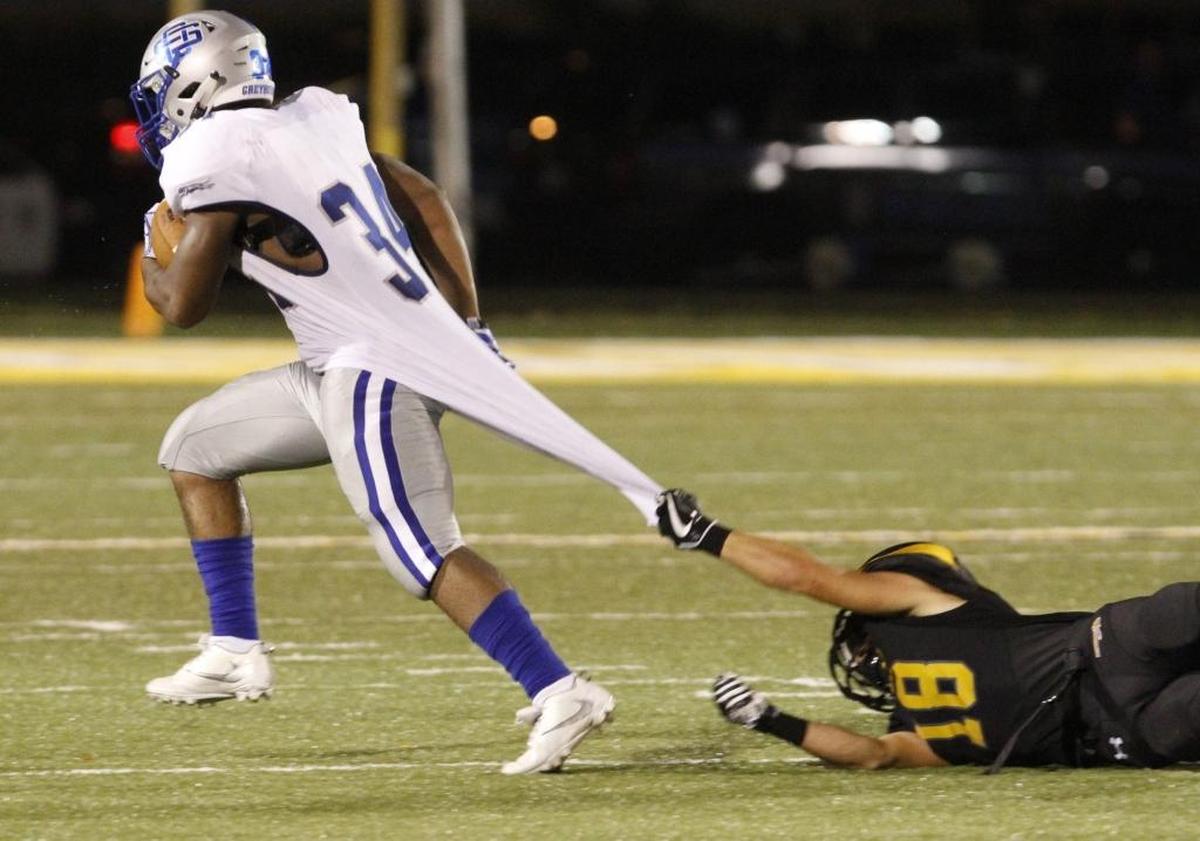 Ocean Springs running back Daveaunce Gaines runs through a shirt tackle by D’Iberville safety Layton Businelle during the third quarter of their game at Warrior Stadium in D’Iberville on Sept. 29. Photographer’s comment: This shot has a little bit of a comedic flair and it reminds me of the days of the tear-away jerseys that were eventually banned.