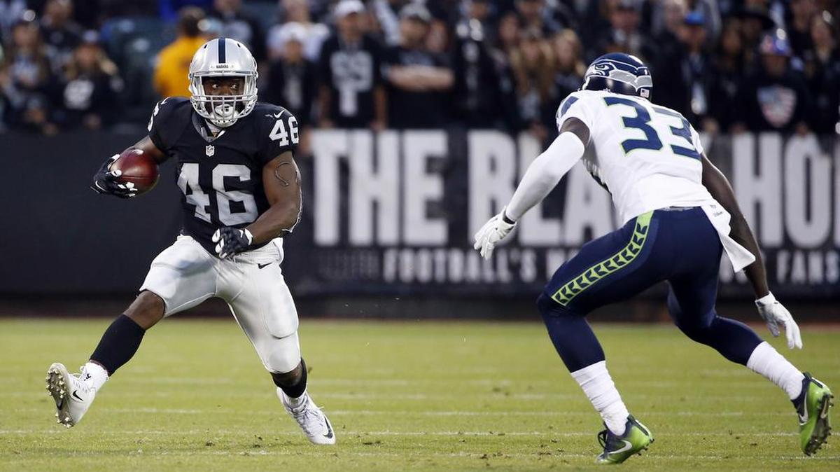Oakland Raiders running back Jalen Richard (46) tries to get around Seattle Seahawks strong safety Kelcie McCray (33) during the first half of a preseason NFL football game on Sept. 1 in Oakland, Calif.