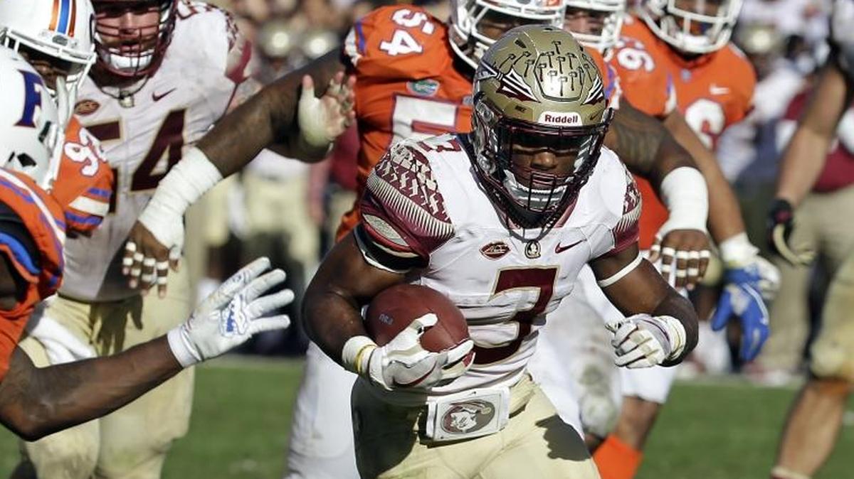 Florida State running back Cam Akers (3) runs past Florida defensive back Duke Dawson, left, for a 10-yard touchdown on Nov. 25 in Gainesville, Fla. Florida State won 38-22.