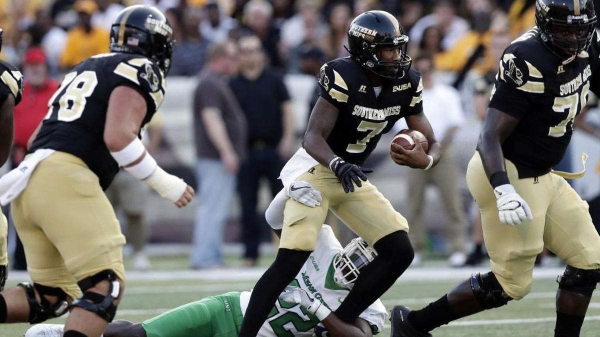 Southern Miss quarterback Kwadra Griggs (7) is tackled by North Texas linebacker E.J. Ejiya (22) as he tries to follow his blockers during the first half of their game in Hattiesburg on Sept. 30.