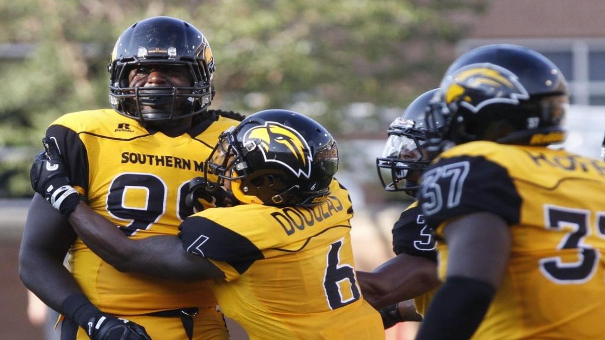 Southern Miss defensive end Jacques Turner, left, and defensive back Kelsey Douglas celebrate a sack by Turner against Kentucky during the third quarter of their game at M.M. Roberts Stadium in Hattiesburg on Saturday.