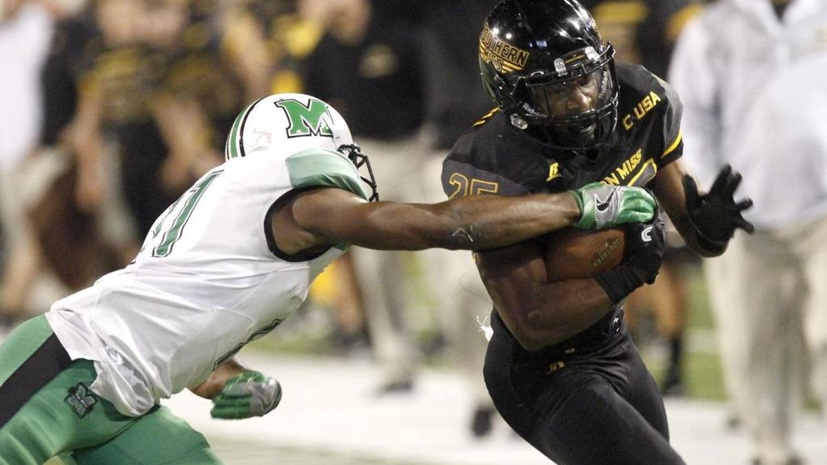 Marshall Rodney Allen tries to strip the ball from Southern Miss running back Ito Smith on Oct. 29 in Hattiesburg.