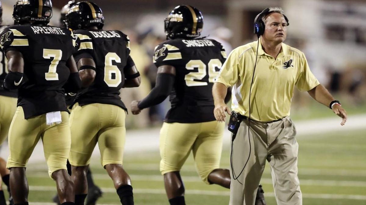 Southern Miss head coach Jay Hopson calls out to his players as they leave the field during the second half of their game against North Texas in Hattiesburg Saturday.