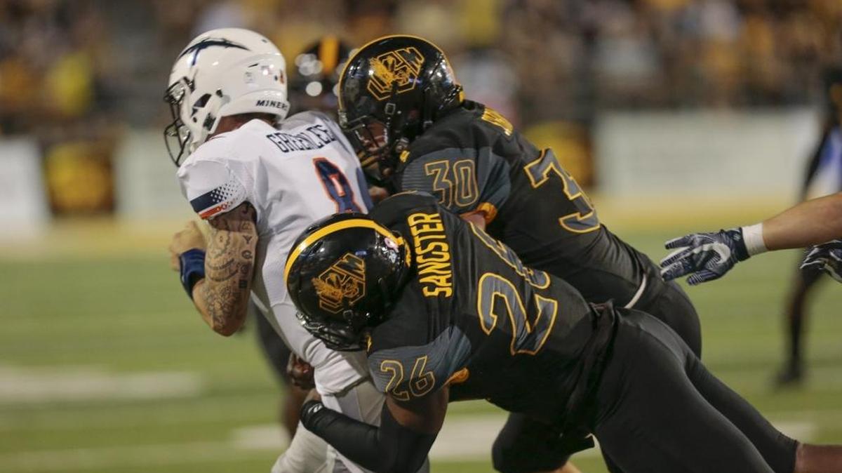 Southern Miss linebacker Jeremy Sangster (26) and defensive end Paxton Schrimsher (30) tackle UTEP quarterback Zack Greenlee (8) during the game in Hattiesburg on Oct. 14, 2017.