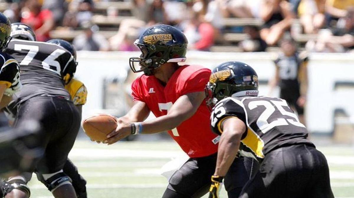 Southern Miss quarterback Kwadra Griggs hands the ball off to running back Ito Smith during the 2016 spring game in Hattiesburg. Griggs and Keon Howard will compete at quarterback this spring.