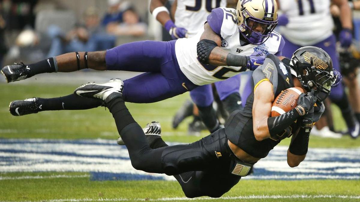 Southern Miss wide receiver DJ Thompson (5) makes a catch against Washington defensive back Budda Baker (32) during the Heart of Dallas Bowl on Dec. 26 in Dallas.