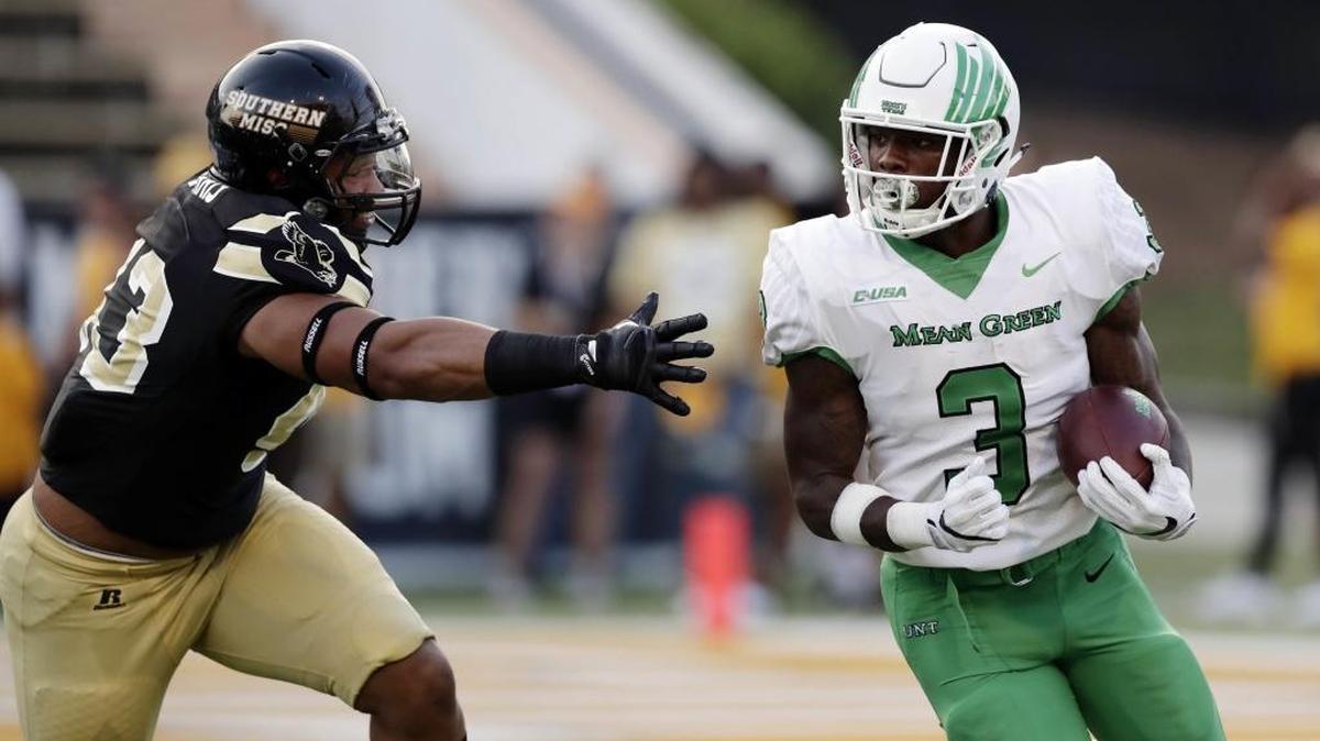 North Texas running back Jeffery Wilson (3) evades a tackle by Southern Miss defensive lineman LaDarius Harris (43) during their game in Hattiesburg Saturday.