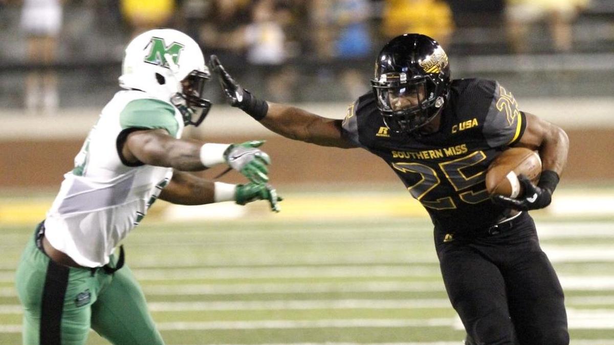 Southern Miss running back Ito Smith uses a stiff arm to escape grasp of a Marshall defender, Saturday, Oct. 29, 2016, at M. M. Roberts Stadium in Hattiesburg.