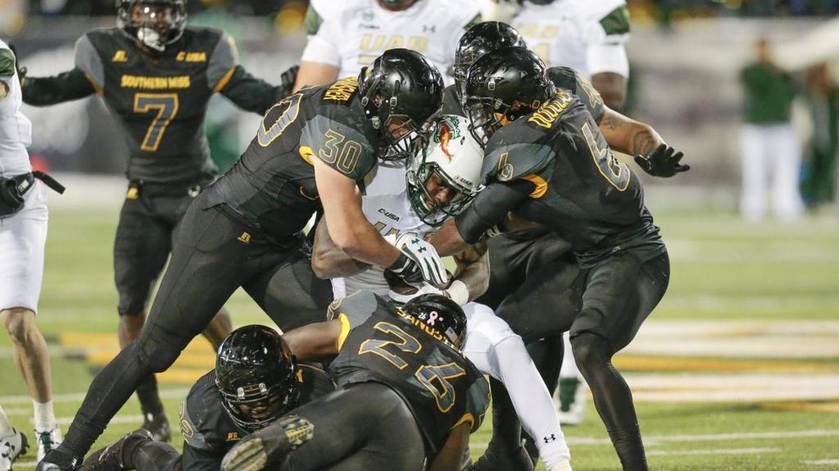 UAB running back Spencer Brown runs into a crowd of Southern Miss defenders during the game at Roberts Stadium in Hattiesburg on Oct. 28.