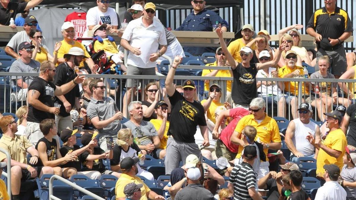 A Southern Miss fan holds up a caught foul ball during the fifth inning of the C-USA tournament championship game at MGM Park in Biloxi on May 28, 2017.
