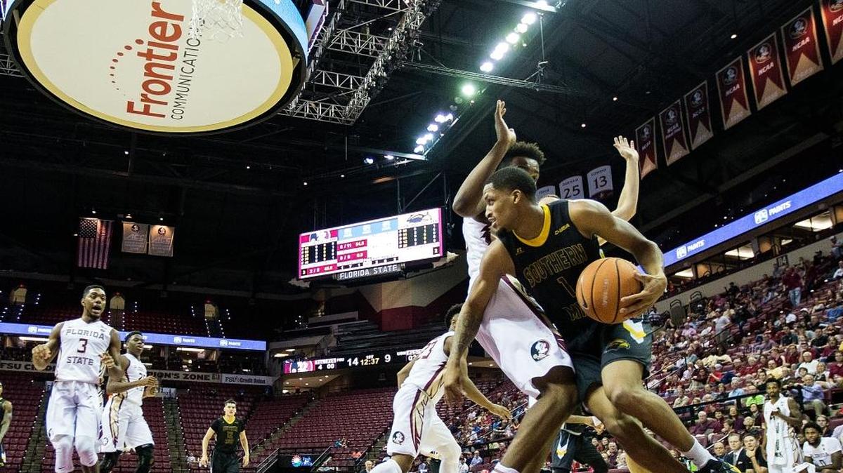 Southern Miss guard Cortez Edwards (1) drives the baseline against Florida State guard PJ Savoy (5).