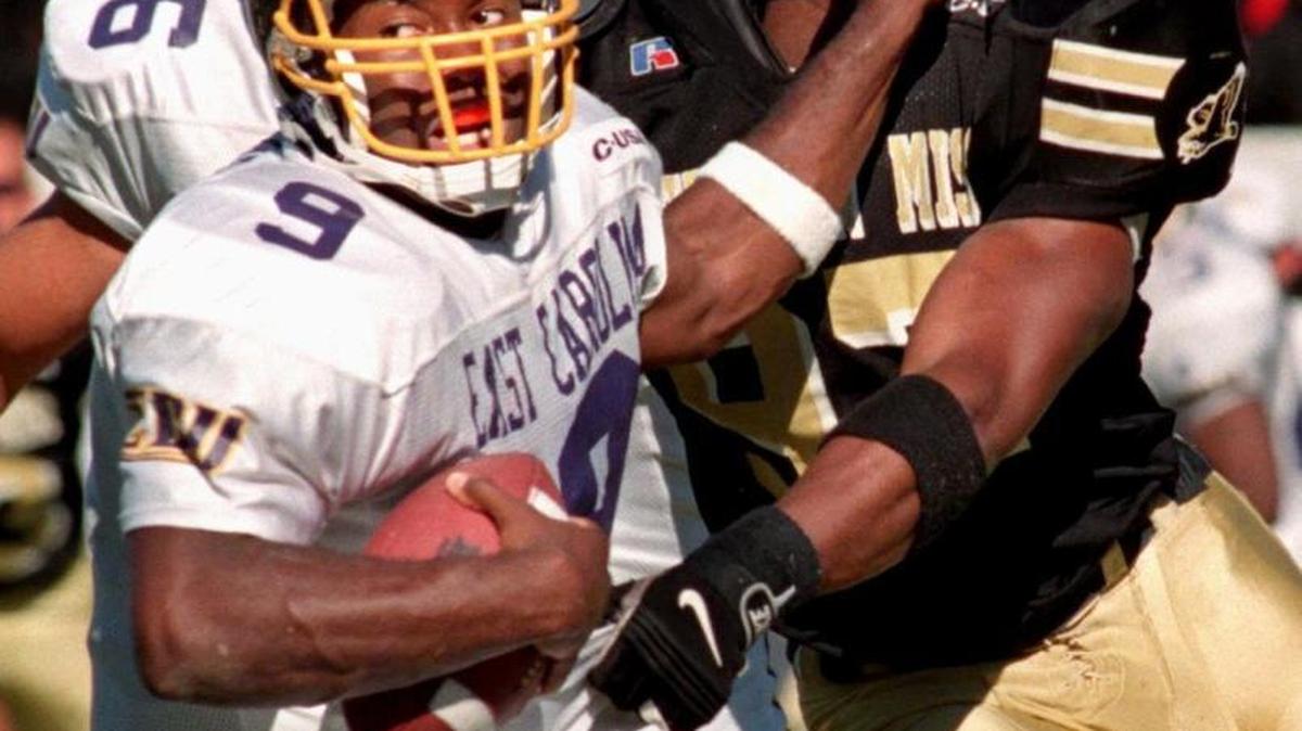 East Carolina quarterback, David Garrard, grabs the facemask of Southern Miss defensive end Adalius Thomas during their game in October, 1998. USM will wear throw-back uniforms similar to the one worn by Thomas in this photo.
