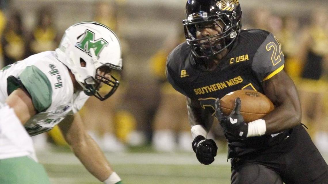 Southern Miss running back George Payne gets a first down as Marshall's Blake Keller defends on Oct. 29, 2016, Roberts Stadium in Hattiesburg.